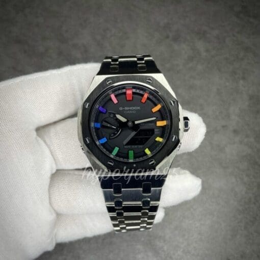 Unique Casio G-Shock 2100 watch with a signature rainbow color scheme for the hour markers, complemented by a black bezel and stainless steel bracelet.